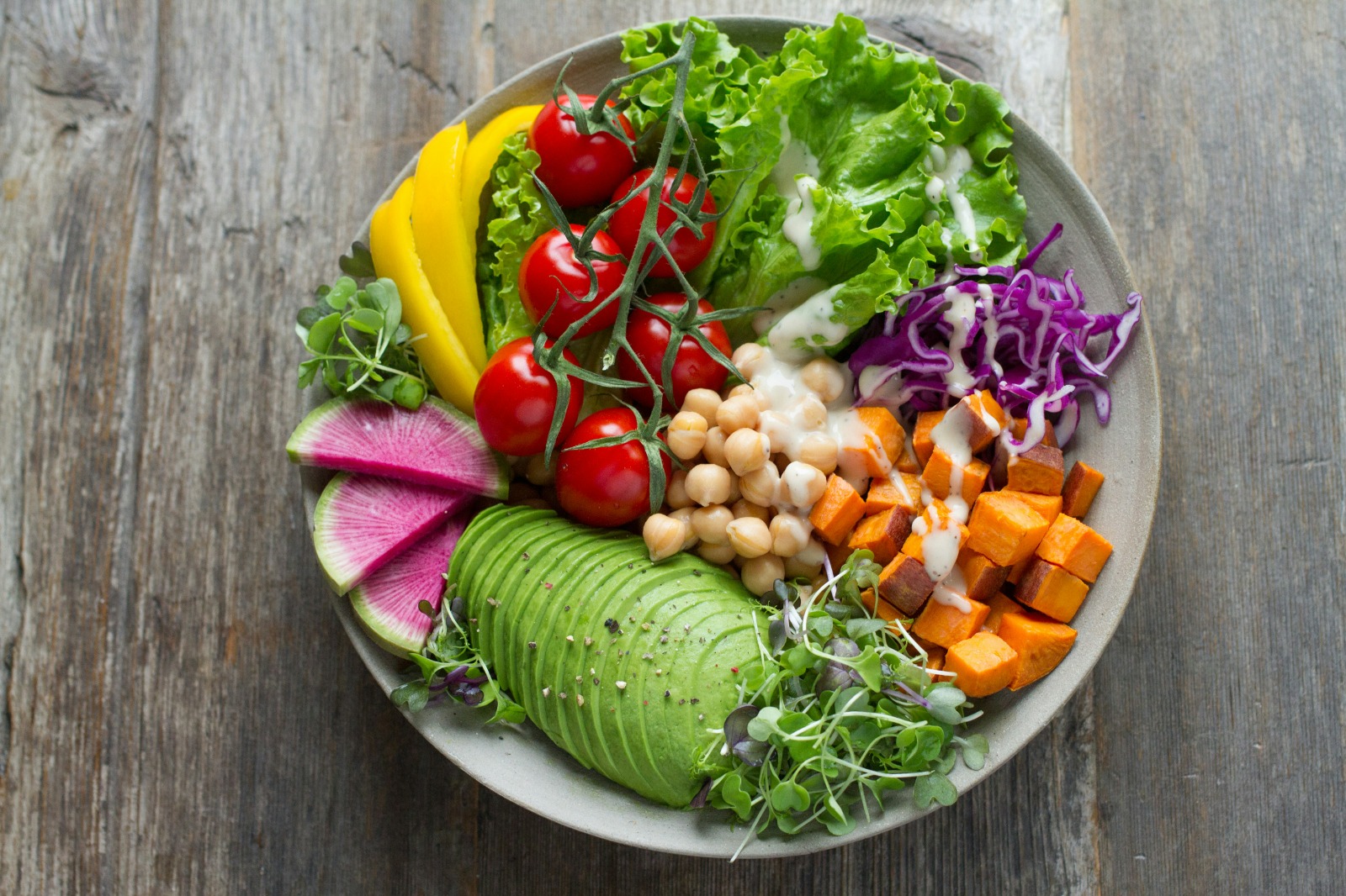 Colourful bowl of fresh vegetables, chickpeas and avocado